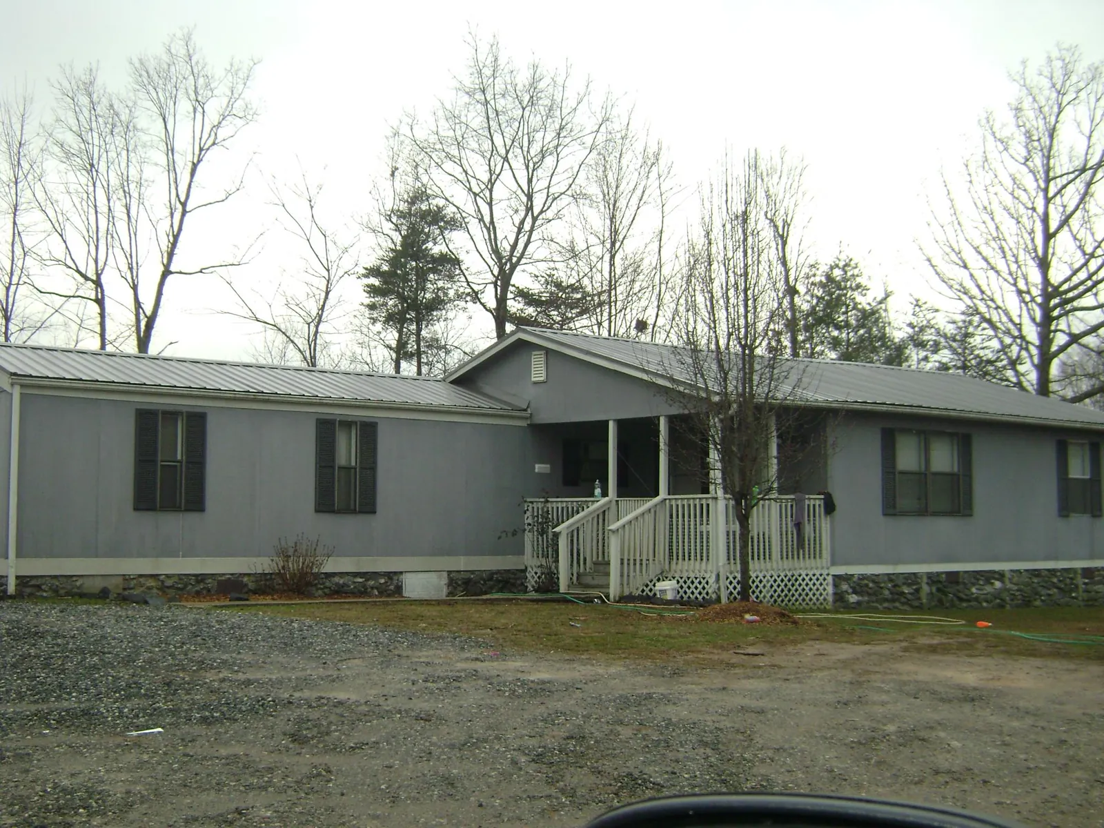 Metal roof over a manufactured home with a covered front porch in Woodville