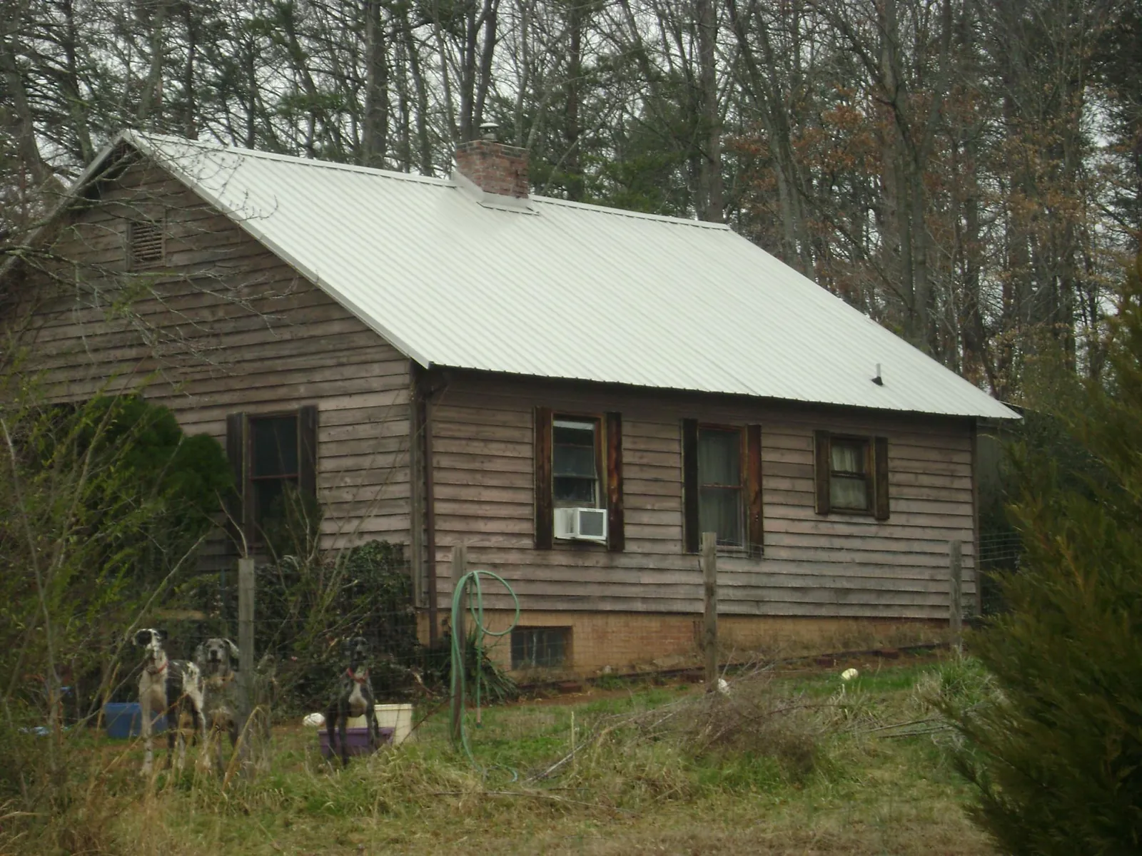 White metal roof on an old wood sided farmhouse, from a Metal Roof Installation job in Woodville